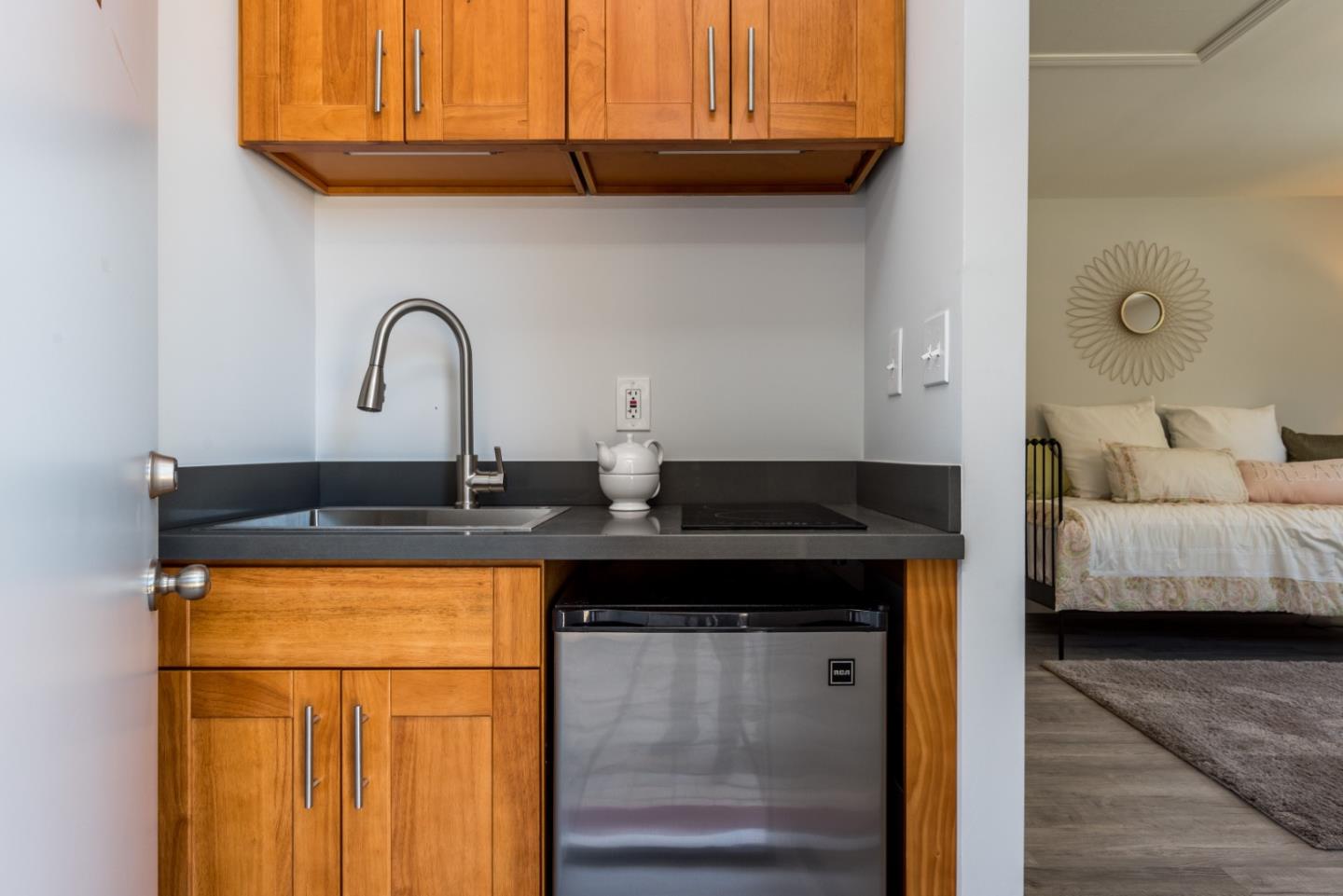 739 Prospect Row San Mateo, CA 94401 - Photo 21 of 27 a kitchen with stainless steel appliances granite countertop a sink and cabinets