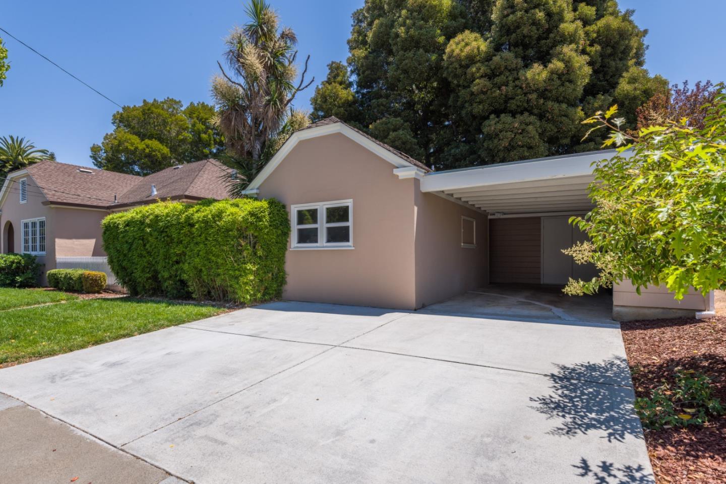 739 Prospect Row San Mateo, CA 94401 - Photo 22 of 27 a front view of a house with a yard and garage