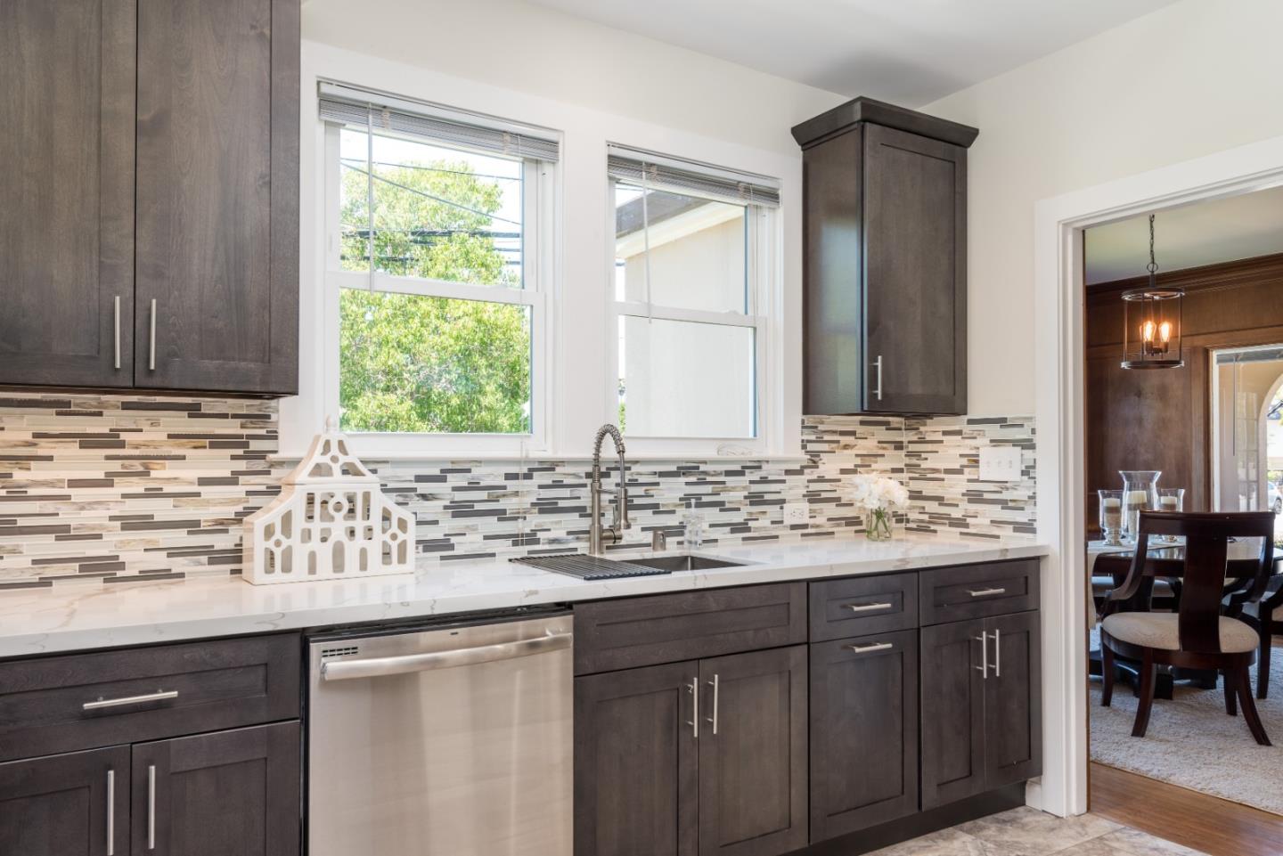 739 Prospect Row San Mateo, CA 94401 - Photo 9 of 27 a kitchen with granite countertop a sink and a wooden cabinets
