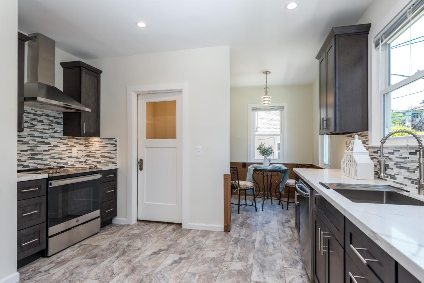 739 Prospect Row San Mateo, CA 94401 - Photo 10 of 27 a kitchen with a sink stove and cabinets