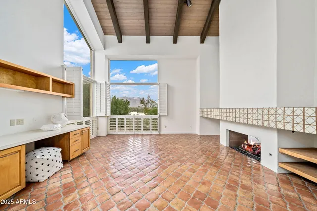 a living room with fireplace furniture and a flat screen tv