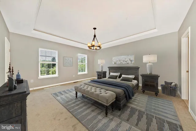 a spacious bedroom with a large bed chandelier and a window