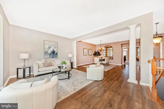 a living room with fireplace furniture and a wooden floor