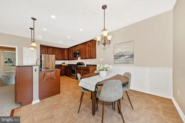 a view of a dining room with furniture and a chandelier