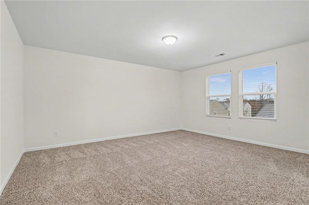 4635 Bluffton Court Cumming, GA 30028 - Photo 18 of 27 a view of an empty room with a window