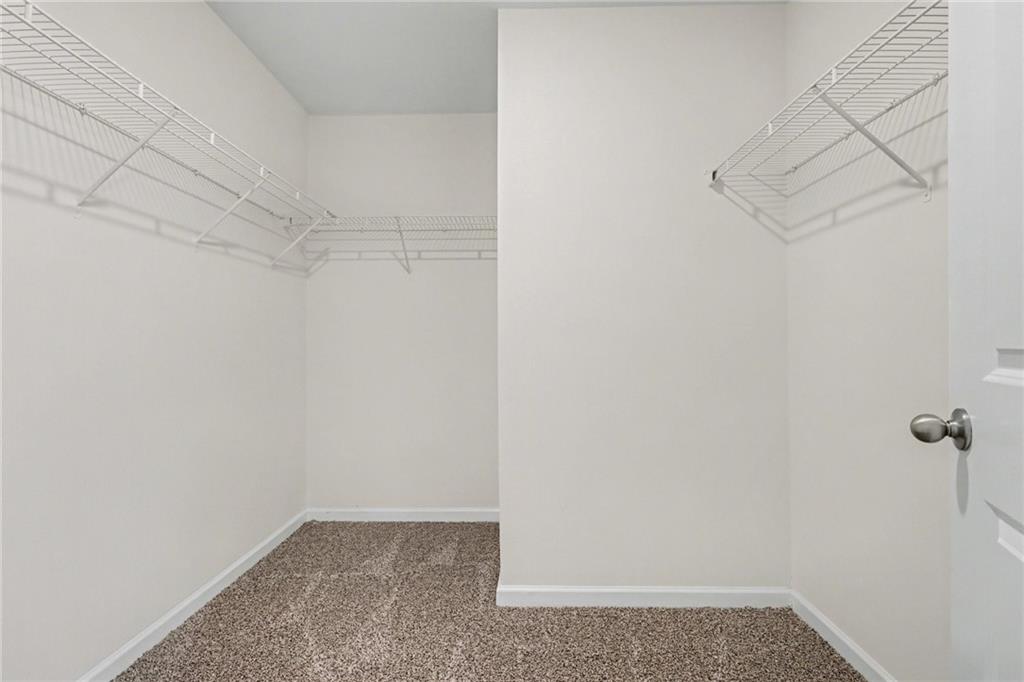 4635 Bluffton Court Cumming, GA 30028 - Photo 20 of 27 a view of a room with racks on the wall