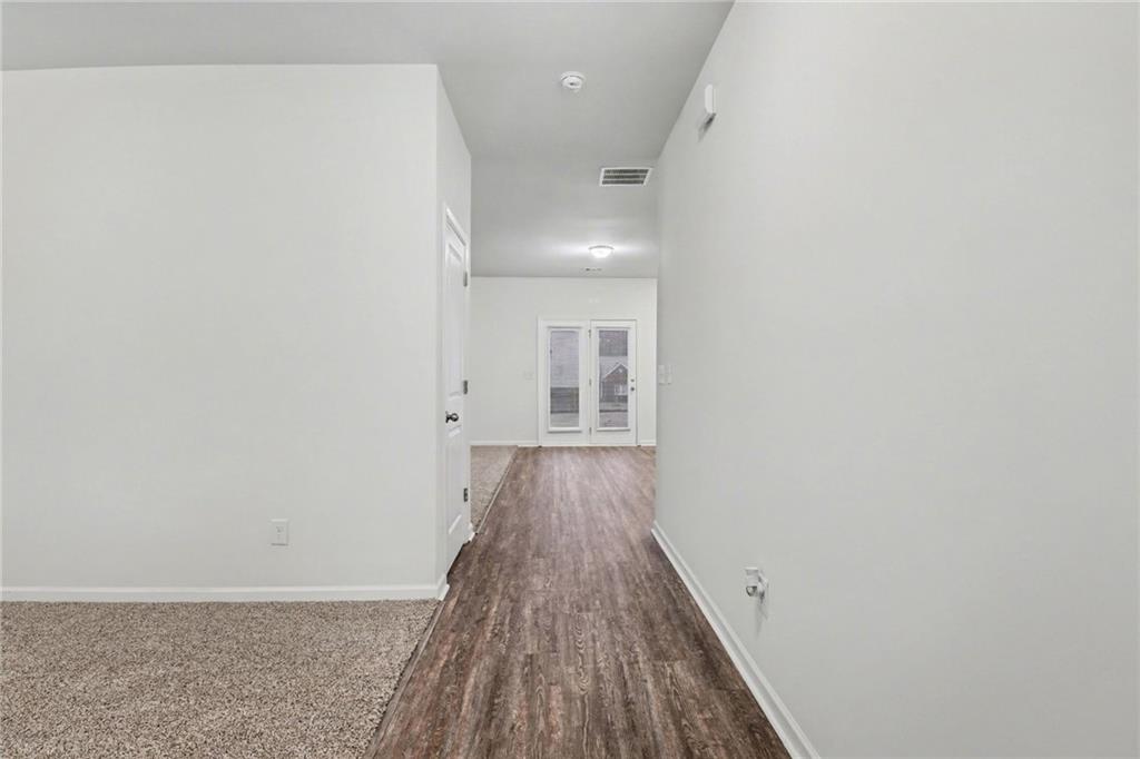 4635 Bluffton Court Cumming, GA 30028 - Photo 6 of 27 a view of a hallway with wooden floor