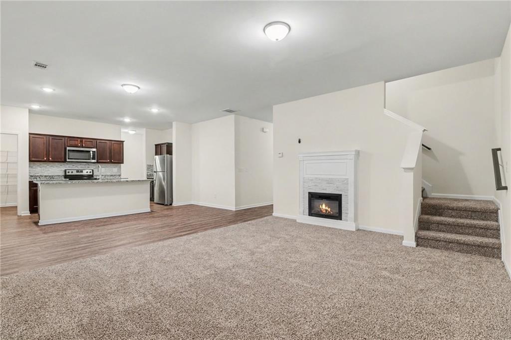 4635 Bluffton Court Cumming, GA 30028 - Photo 7 of 27 a view of an empty room with a fireplace