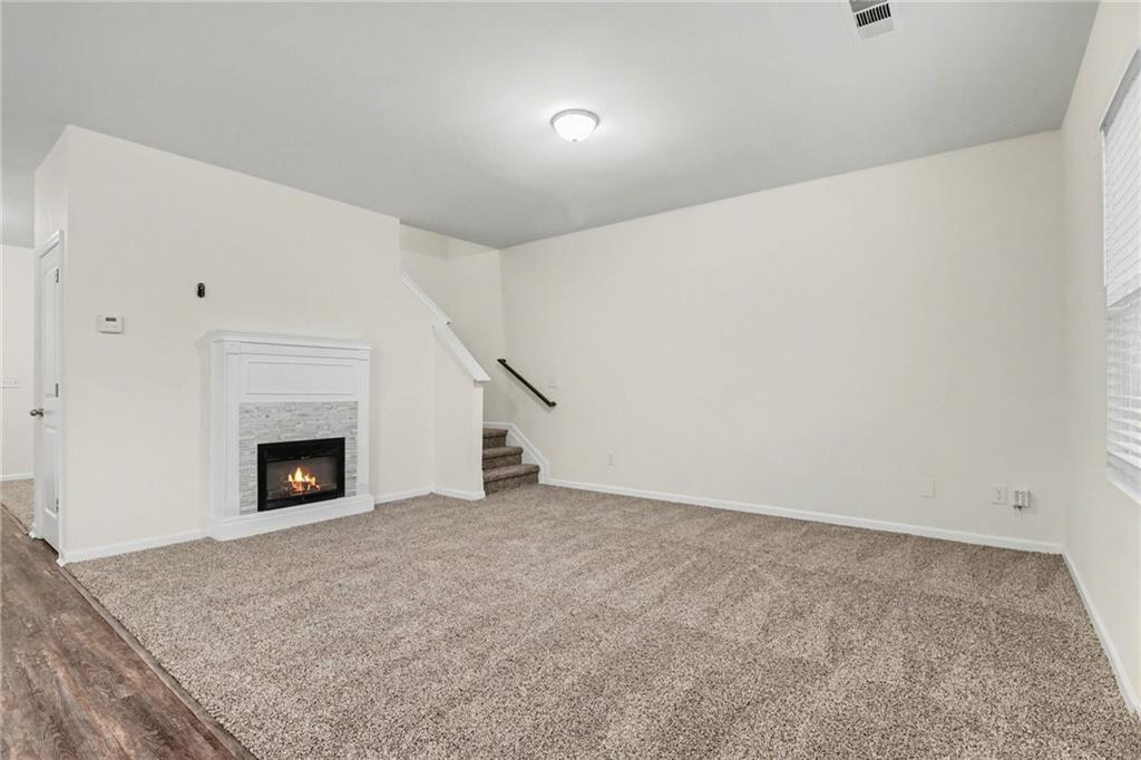 4635 Bluffton Court Cumming, GA 30028 - Photo 8 of 27 a view of an empty room with a fireplace