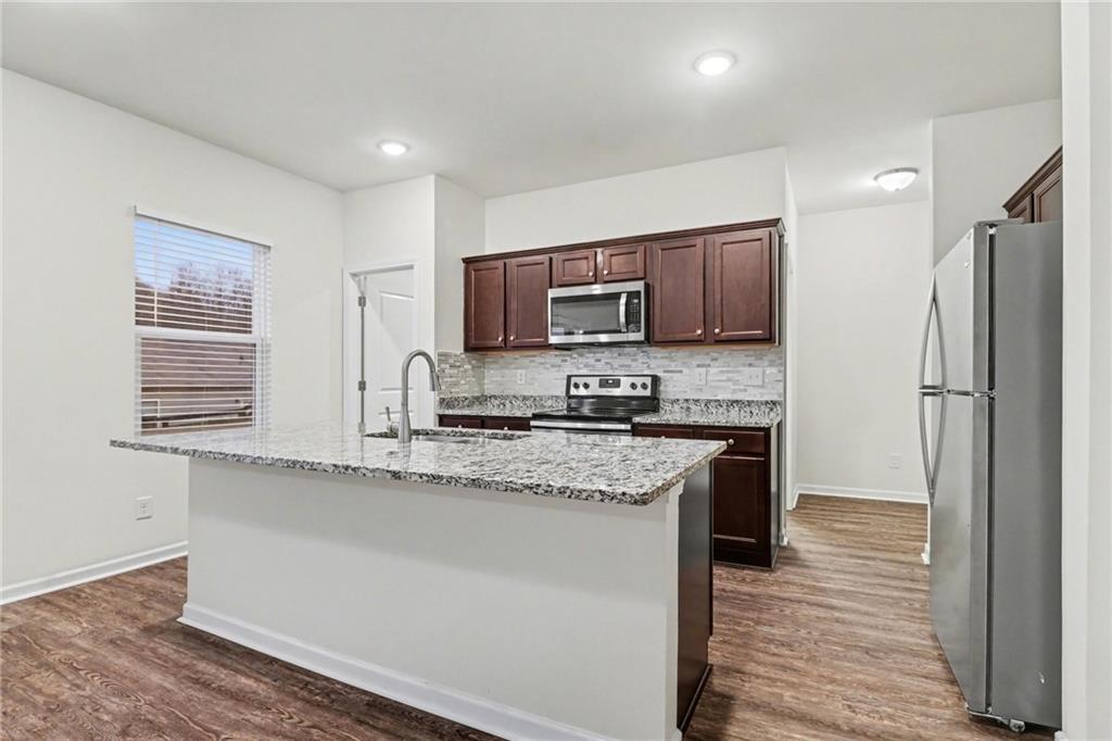 4635 Bluffton Court Cumming, GA 30028 - Photo 10 of 27 a kitchen with stainless steel appliances granite countertop a refrigerator sink and microwave