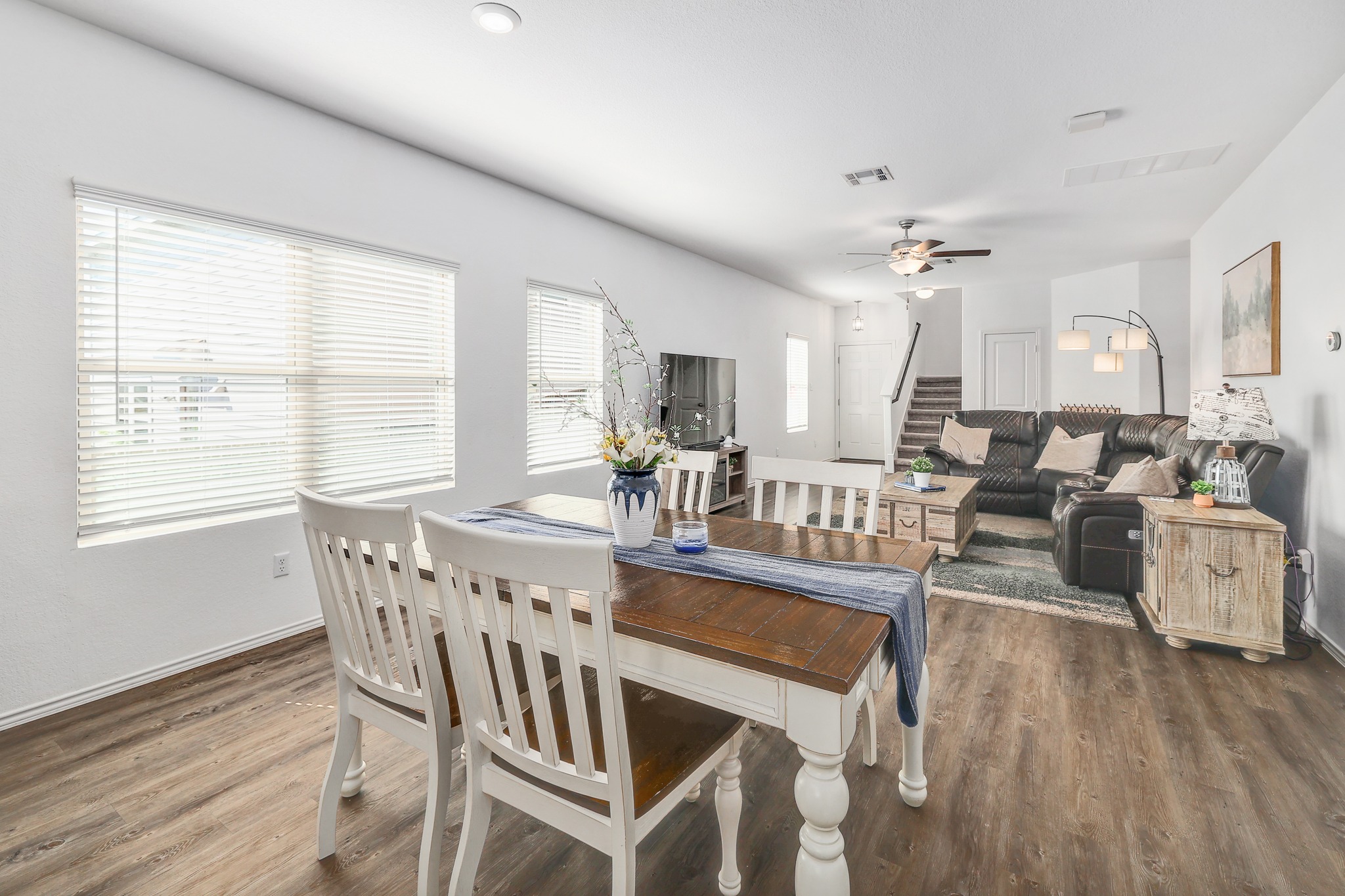 735 Circle Way Jarrell, TX 76537 - Photo 5 of 32 An open dining and living area features wood-inspired flooring and ample window light.