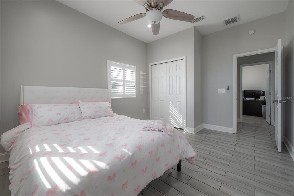 2341 West Chestnut Street Tampa, FL 33607 - Photo 25 of 42 a bedroom with a large bed and a chandelier