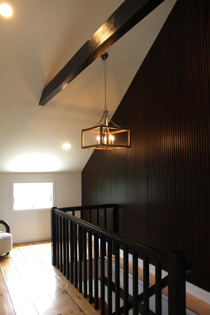 33 Bartlett Road Nantucket, MA 02554 - Photo 14 of 29 a hallway with a chandelier