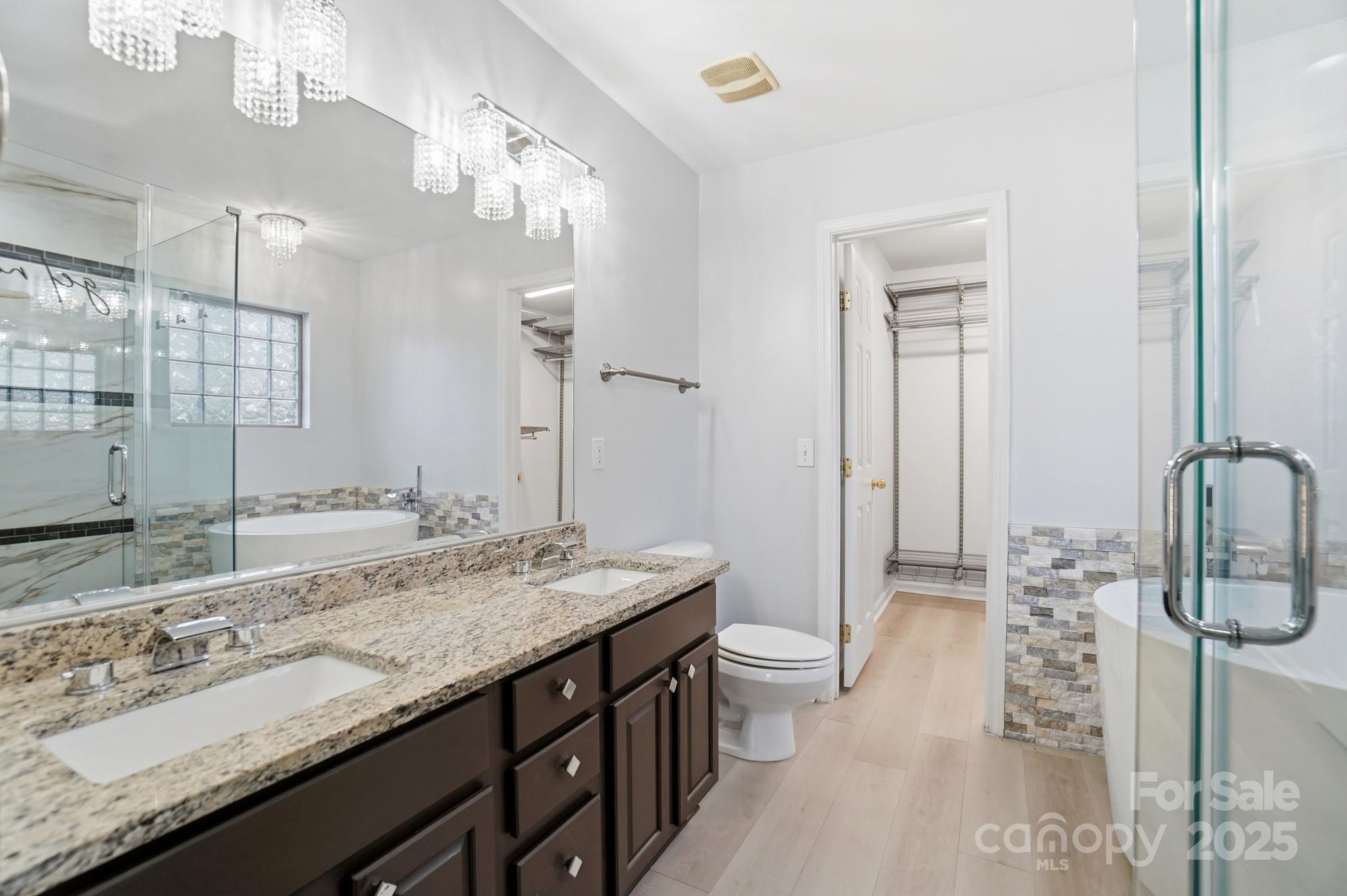 630 Springhouse Place Clover, SC 29710 - Photo 16 of 32 a bathroom with a granite countertop double vanity sink and a mirror