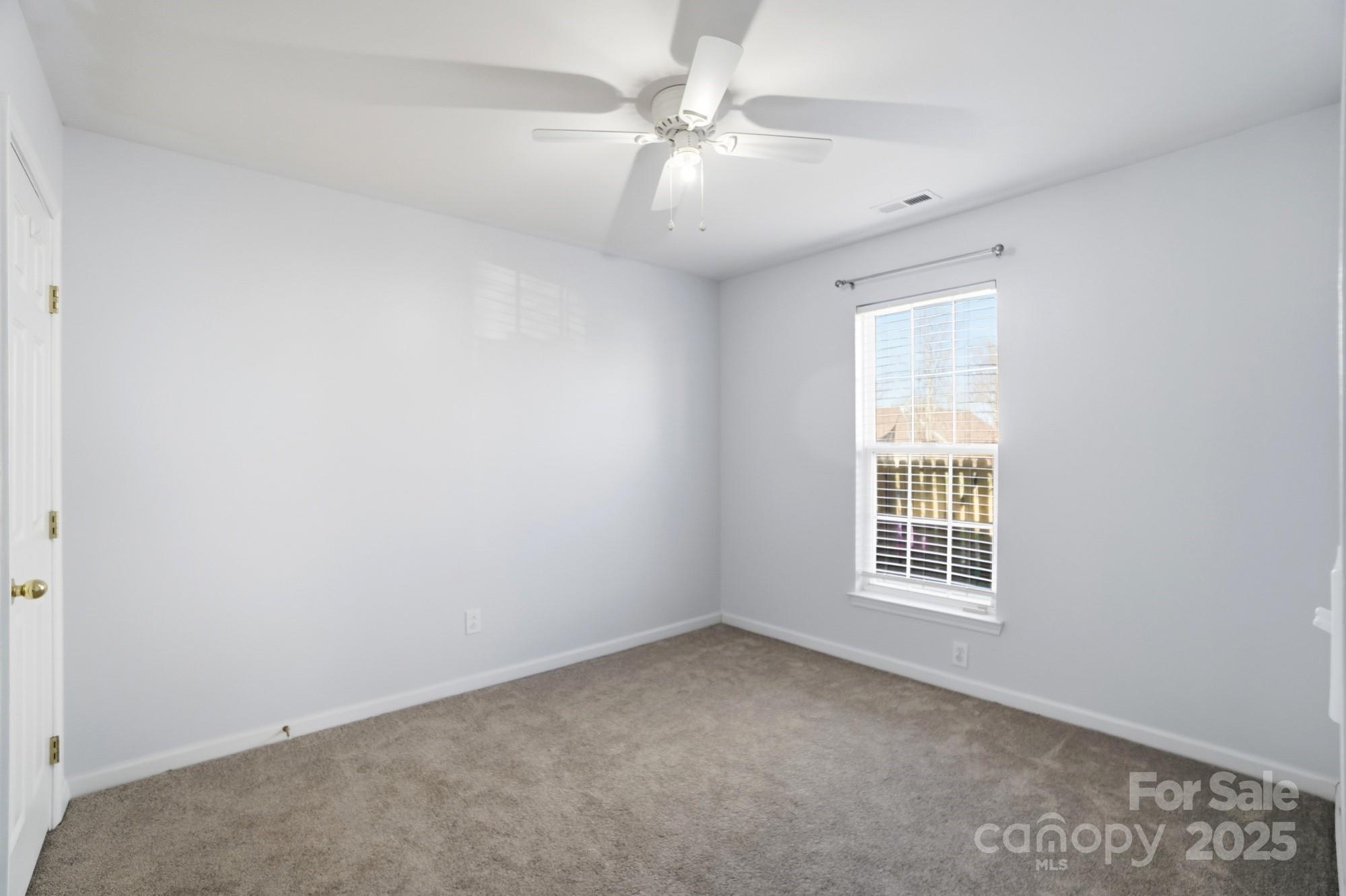 630 Springhouse Place Clover, SC 29710 - Photo 21 of 32 an empty room with windows and ceiling fan