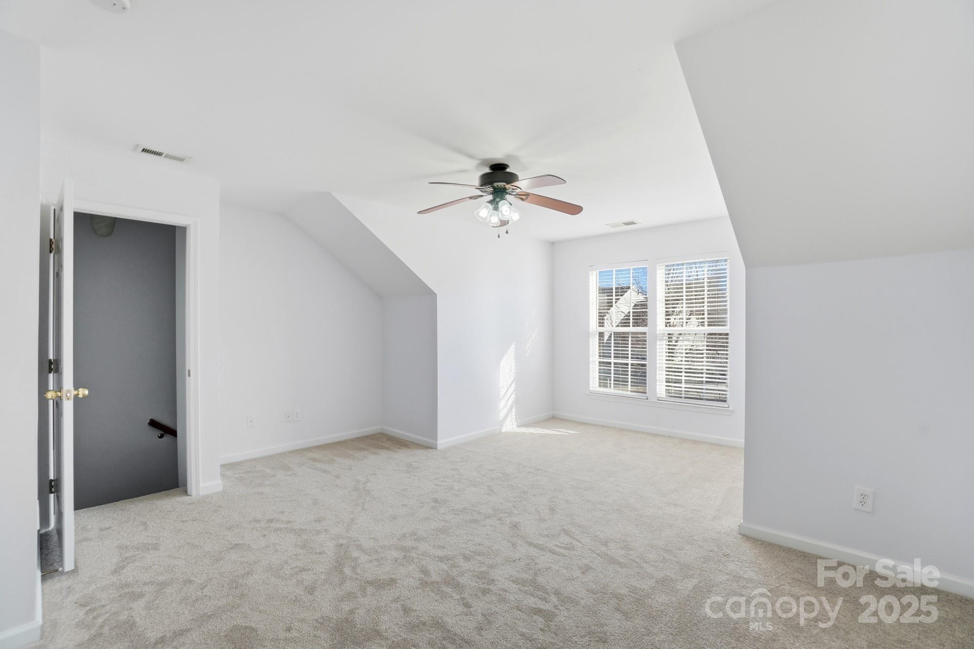 630 Springhouse Place Clover, SC 29710 - Photo 24 of 32 an empty room with windows and ceiling fan