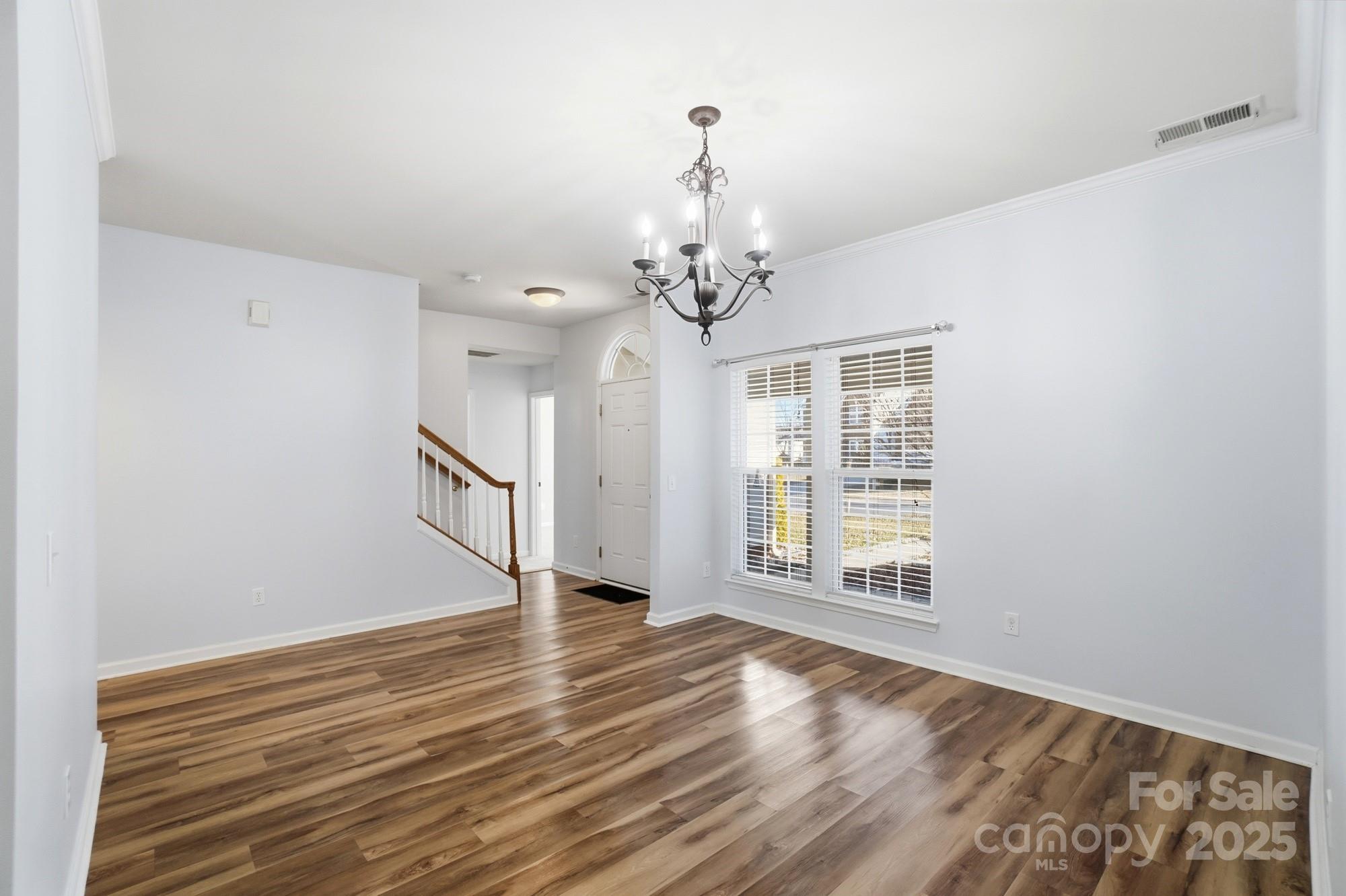 630 Springhouse Place Clover, SC 29710 - Photo 5 of 32 a view of an empty room with wooden floor and a window