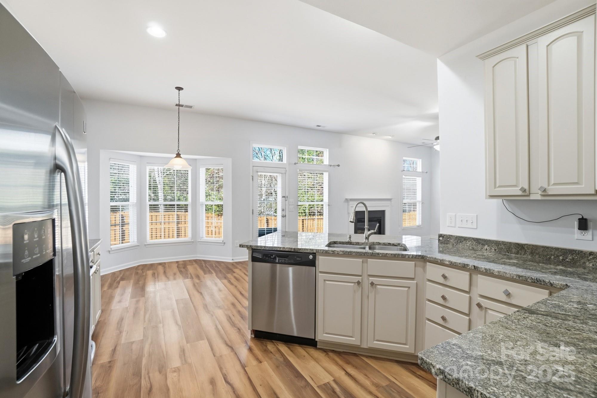 630 Springhouse Place Clover, SC 29710 - Photo 6 of 32 a kitchen with granite countertop a sink a counter space appliances and cabinets