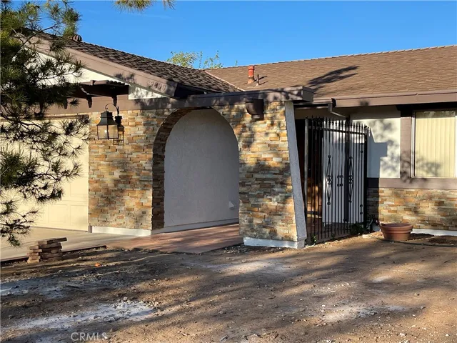 a view of a house with a wooden fence