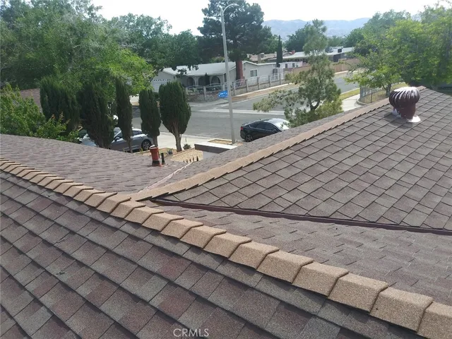 an empty room with windows and fireplace