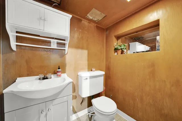 a bathroom with a sink a toilet and mirror