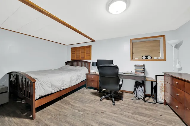 a bedroom with a bed and a desk