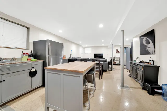 a kitchen that has a lot of cabinets a sink and appliances in it