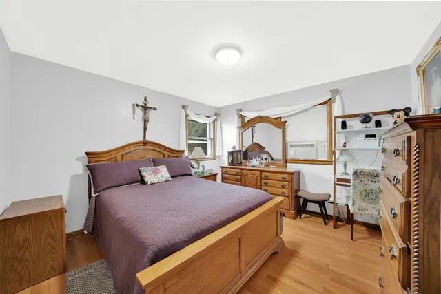 a bedroom with furniture and a large window