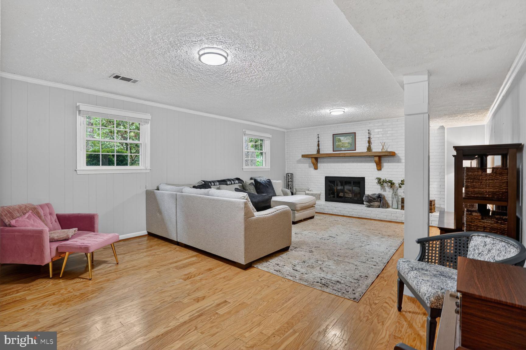 5024 Portsmouth Road Fairfax, VA 22032 - Photo 22 of 38 a living room with furniture a flat screen tv and a fireplace