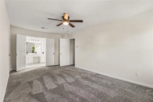 a view of a room with a stylish ceiling fan and entryway