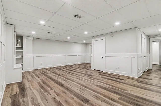 a view of empty room with wooden floor
