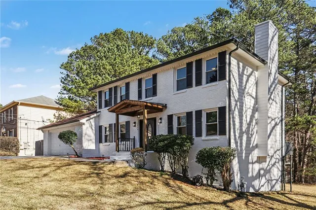 a front view of a house with a garden