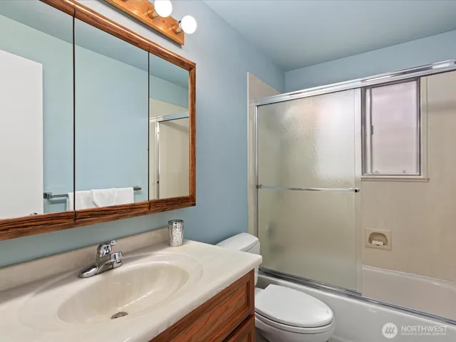 a bathroom with a sink a mirror and a toilet