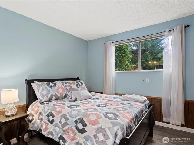 a bedroom with a bed and a night stand