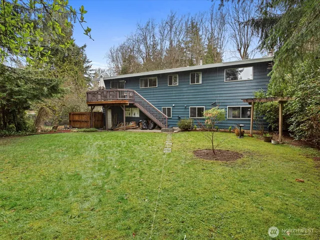 a view of a house with a yard and sitting area