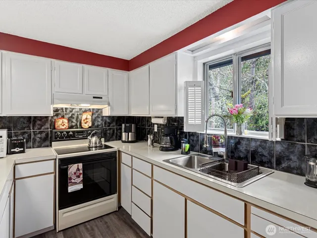 a kitchen with a sink stove and cabinets