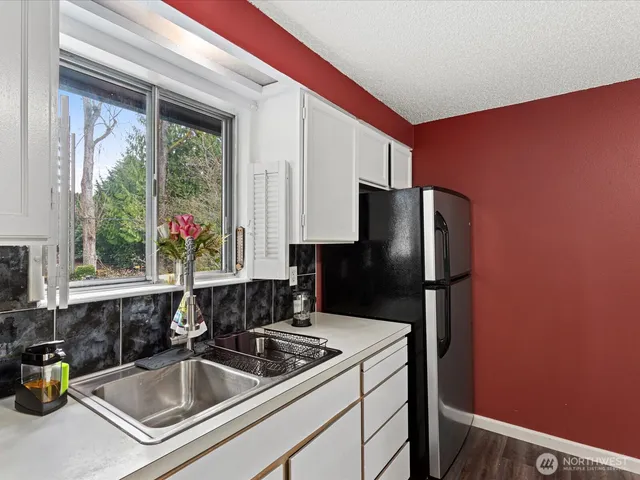 a kitchen with a refrigerator and a sink