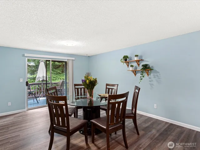 a view of a dining room with furniture window and wooden floor