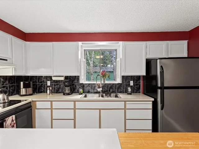 a kitchen with a refrigerator and a sink