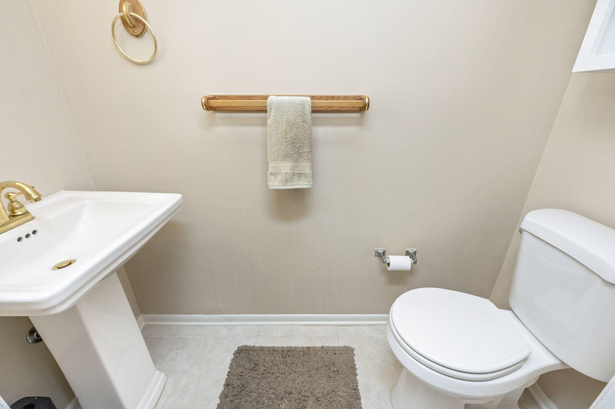 696 Tyner Street, Unit 2 Fort Walton Beach, FL 32547 - Photo 2 of 3 a white toilet sitting next to a bathroom sink