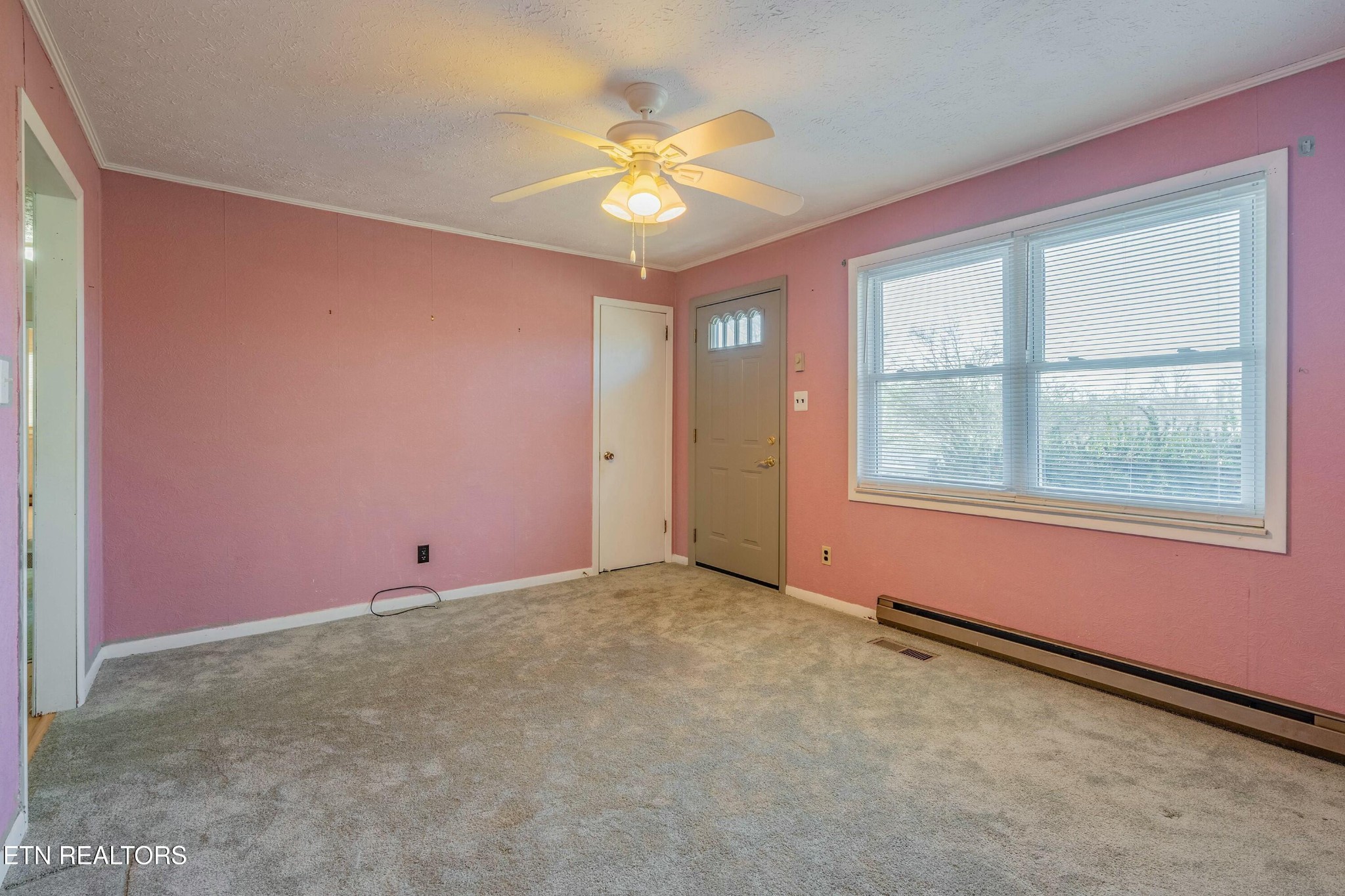 1747 Fairview Road Oliver Springs, TN 37840 - Photo 3 of 20 an empty room with a window and a fan