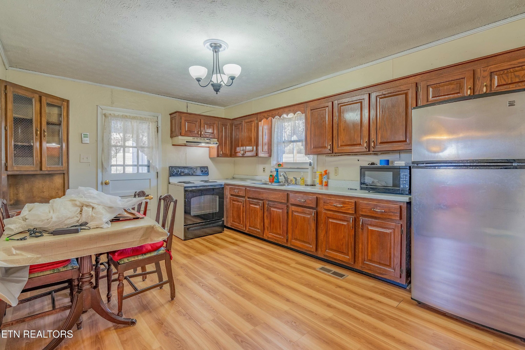 1747 Fairview Road Oliver Springs, TN 37840 - Photo 4 of 20 a kitchen with a refrigerator a stove a sink dishwasher and wooden cabinets with wooden floor