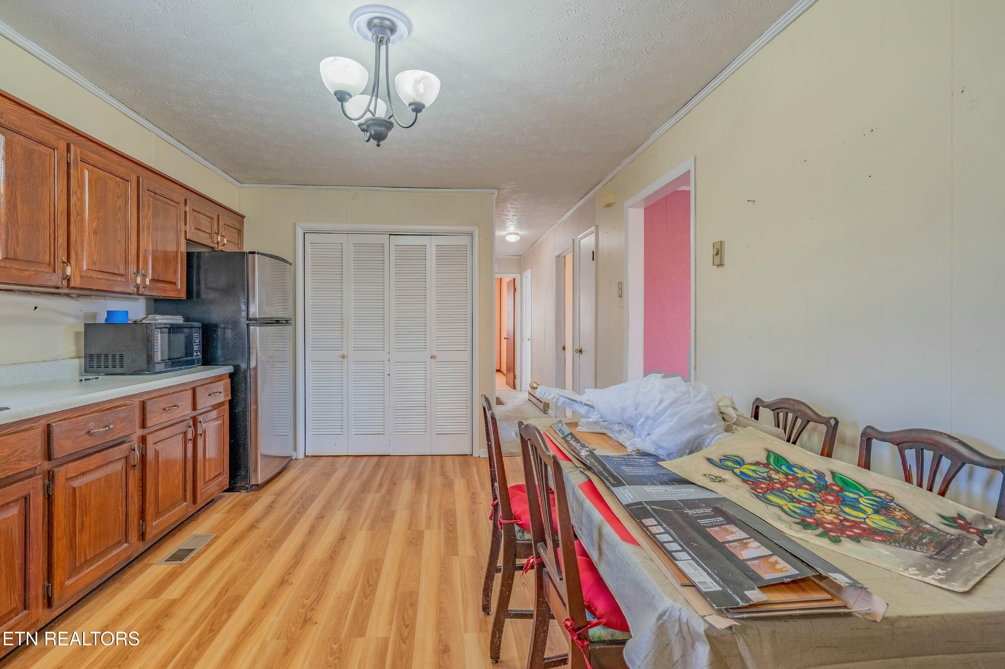 1747 Fairview Road Oliver Springs, TN 37840 - Photo 5 of 20 a bedroom with a bed and a chandelier