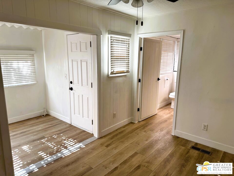 17850 Corkill Road, Unit 94 Desert Hot Springs, CA 92241 - Photo 22 of 39 a view of an empty room with wooden floor and a window
