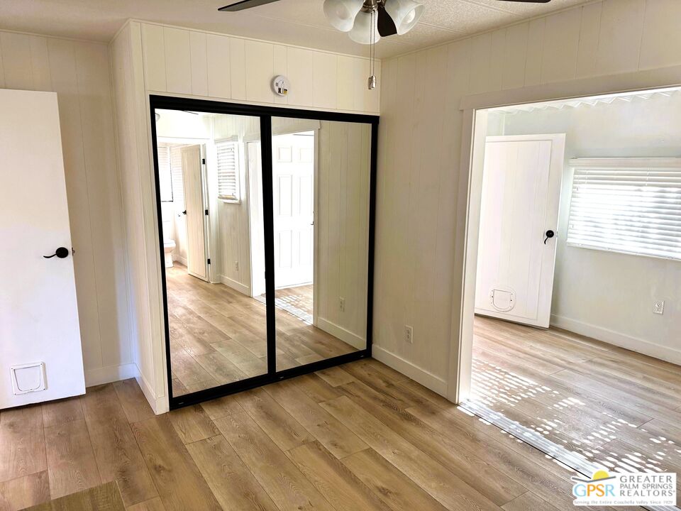 17850 Corkill Road, Unit 94 Desert Hot Springs, CA 92241 - Photo 27 of 39 a view of a hallway with wooden floor and cabinet