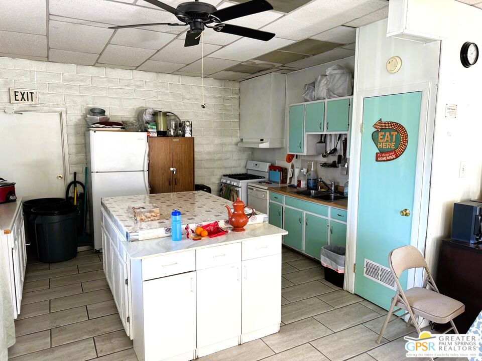 17850 Corkill Road, Unit 94 Desert Hot Springs, CA 92241 - Photo 36 of 39 a kitchen with a stove and a refrigerator