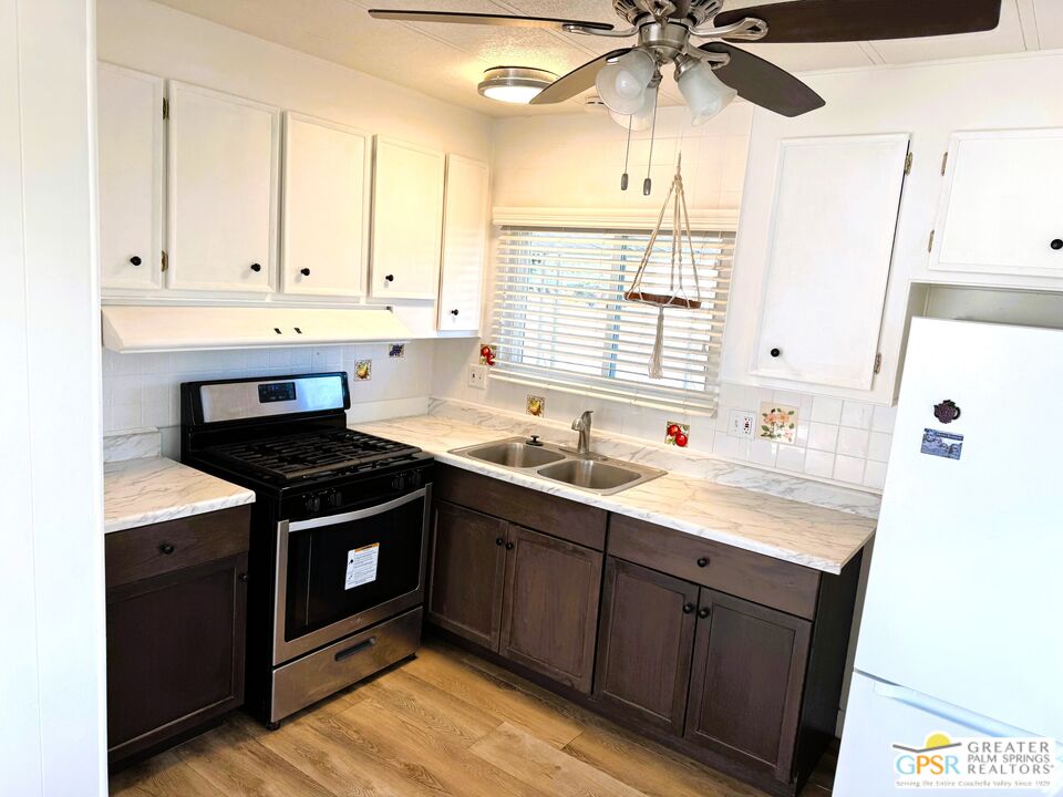17850 Corkill Road, Unit 94 Desert Hot Springs, CA 92241 - Photo 6 of 39 a kitchen with stainless steel appliances granite countertop a sink stove and cabinets
