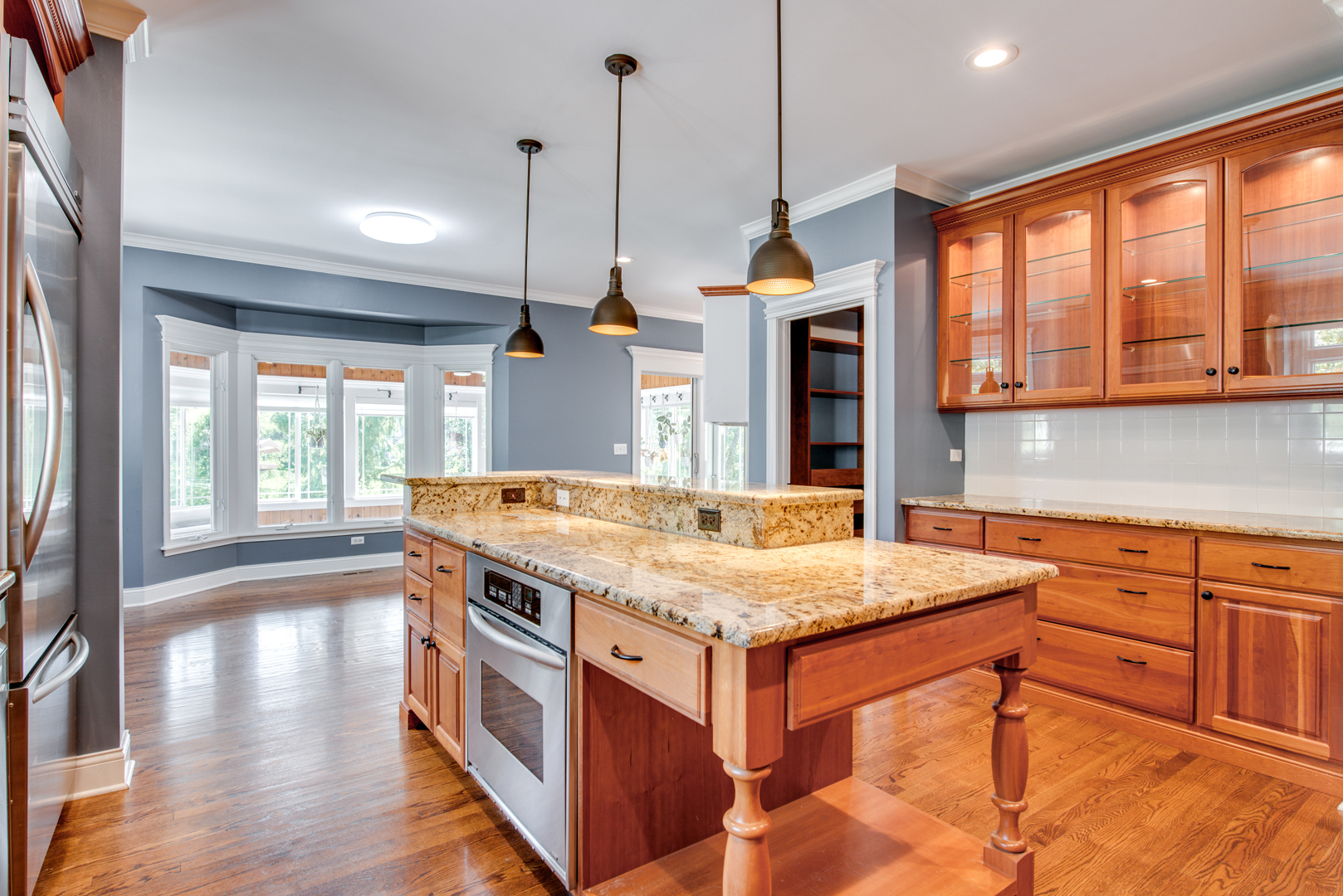 1736 Robert Lane Naperville, IL 60564 - Photo 18 of 69 a kitchen with a stove a sink a center island and a wooden floor
