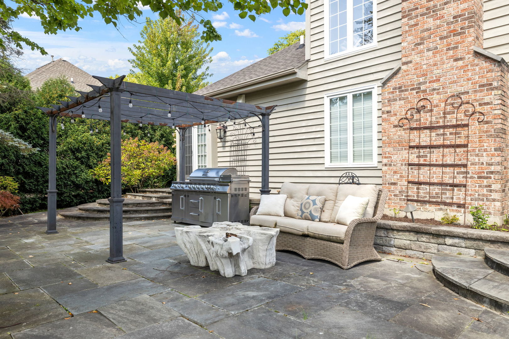 1736 Robert Lane Naperville, IL 60564 - Photo 58 of 69 a view of a patio with couches and table and chairs with wooden fence