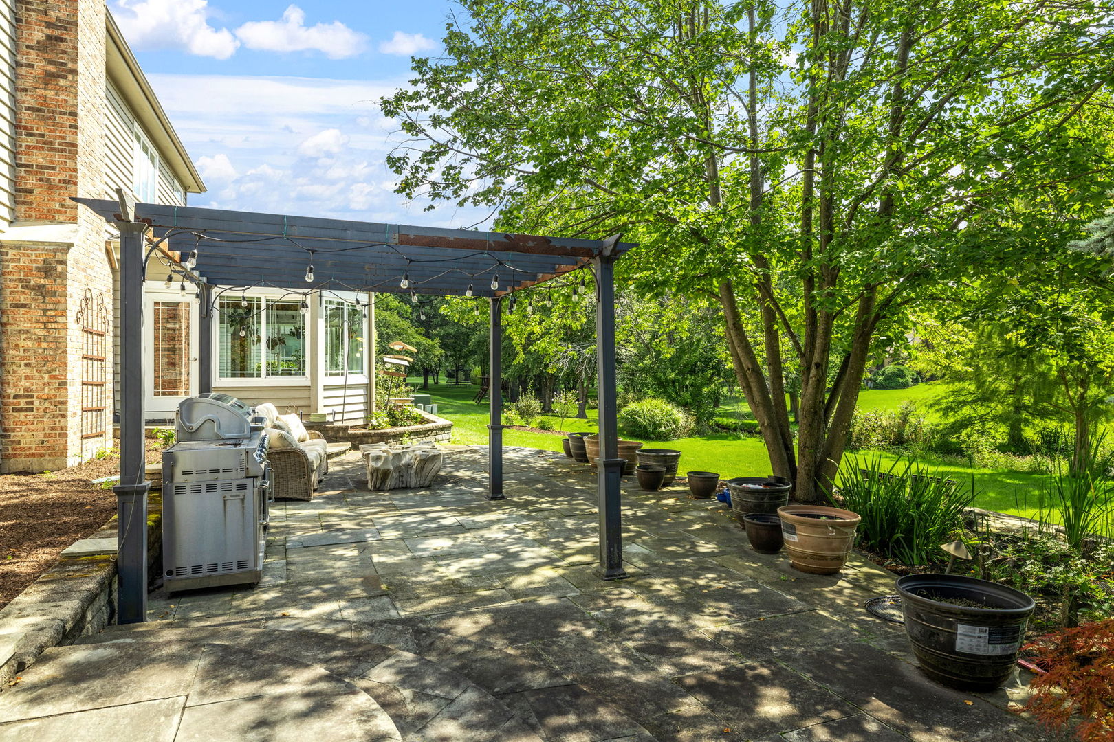 1736 Robert Lane Naperville, IL 60564 - Photo 59 of 69 a view of a house with backyard sitting area and garden